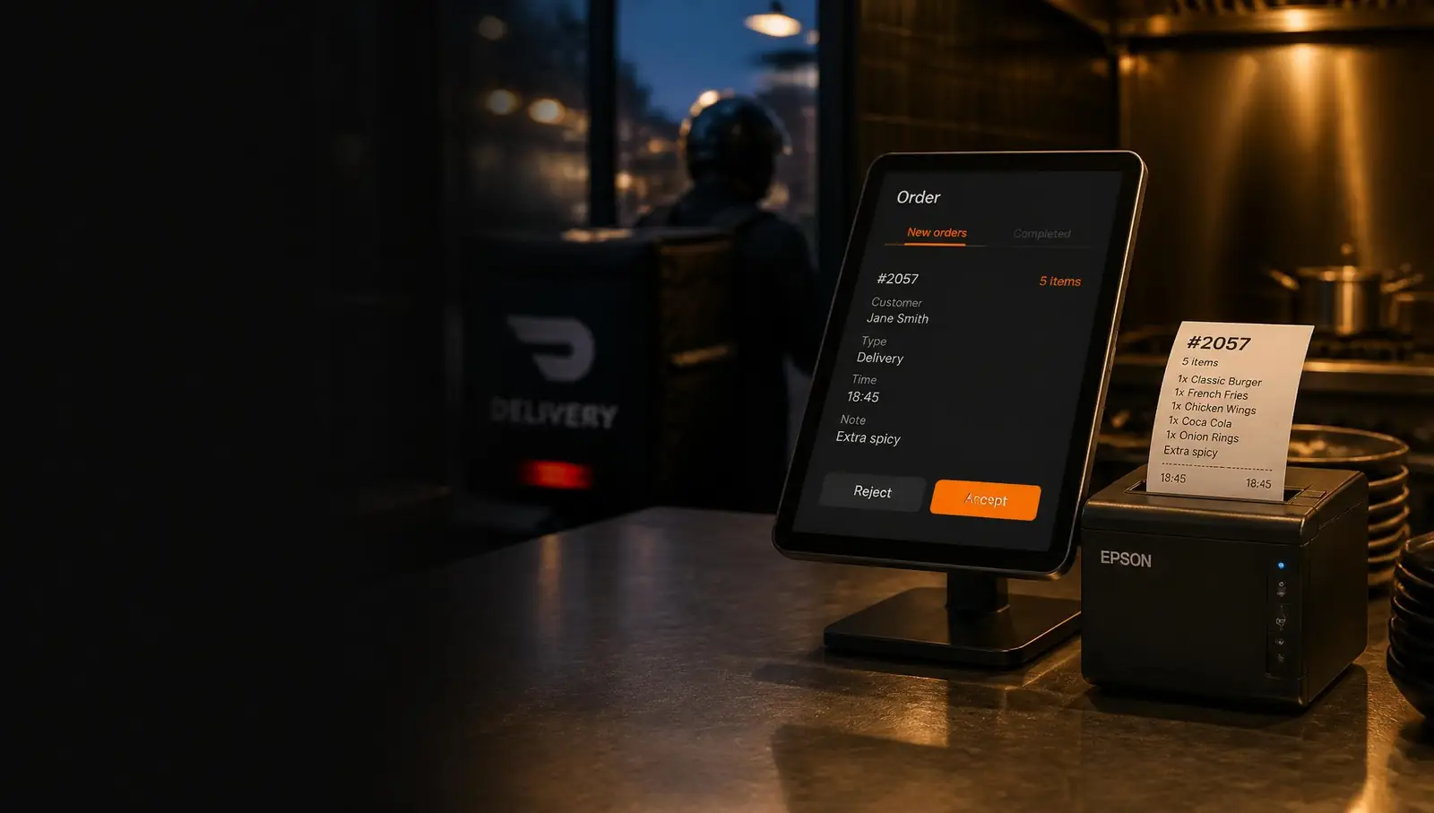 Ordreskærm på tablet og kvitteringsprinter i restaurantkøkken
